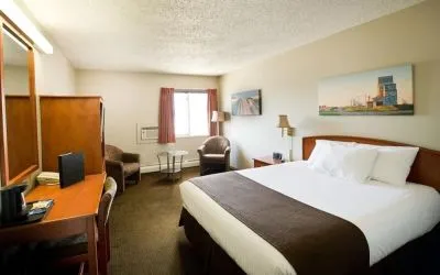 Day use room with living area, work desk and private bathroom at Riviera Motor Inn.