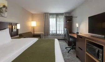 Day use room with TV, sofa, work desk and private bathroom at Comfort Inn Sudbury Regent Street.