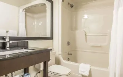 Guest bathroom with tub and free toiletries at Comfort Inn Sept-Iles. 