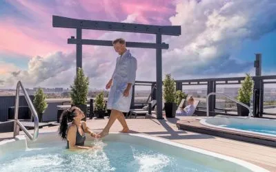Hotel terrace with outdoor pool and hot tub at Acclaim Hotel Calgary Airport.
