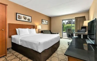 Day use room with TV, sofa, work desk and private bathroom at Comfort Inn Winnipeg II South.