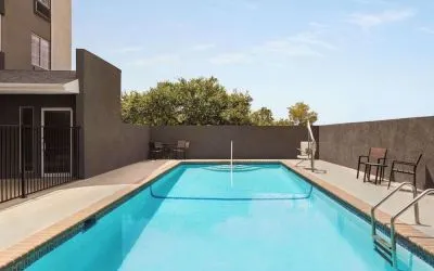 Refreshing outdoor pool at La Quinta Inn & Suites - North Stone Oak.