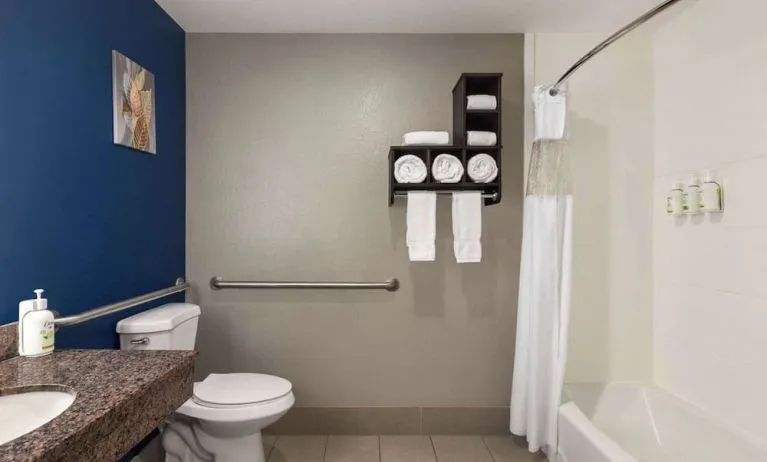 Guest bathroom with shower and tub at La Quinta Inn & Suites - North Stone Oak.