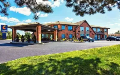Hotel entrance and parking area at Comfort Inn Cobourg.