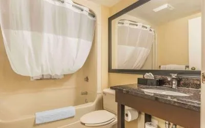 Guest bathroom with tub and free toiletries at Comfort Inn Cobourg.