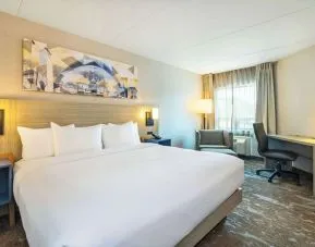 Bright and spacious day use room with work desk and sofa at Comfort Inn Kingston HWY 401.