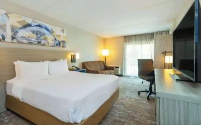 Standard day use room with TV, work desk, sofa and private bathroom at Comfort Inn Kingston HWY 401.