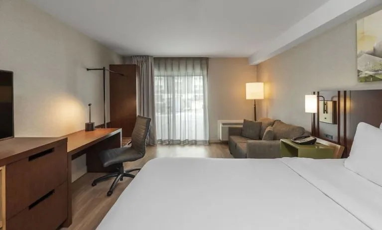 Day use room with TV, work desk and sofa at Comfort Inn Dryden.