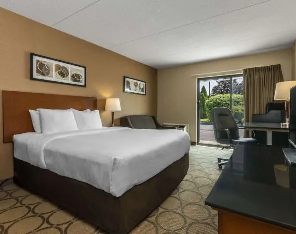 Comfortable day use room with TV, work desk and sofa at Comfort Inn Baie Comeau.