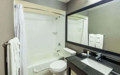 Guest bathroom with tub and free toiletries at Comfort Inn Amherst.
