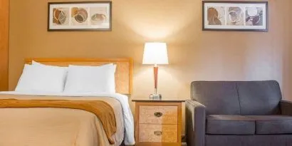 Day use room with TV, work desk and sofa at Comfort Inn Brantford.