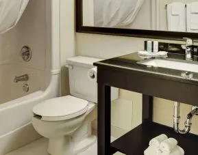 Guest bathroom with tub and free toiletries at Comfort Inn Brantford.
