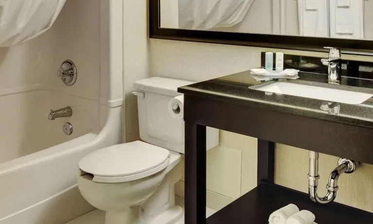Guest bathroom with tub and free toiletries at Comfort Inn Brantford.
