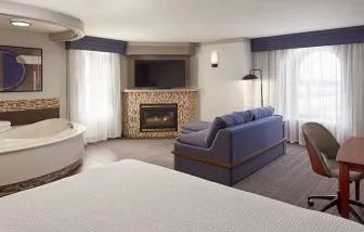Day use suite with work desk, hot tub and living area with fireplace at Courtyard By Marriott Waterloo St. Jacobs.