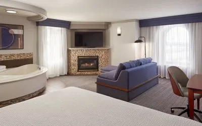 Day use suite with work desk, hot tub and living area with fireplace at Courtyard By Marriott Waterloo St. Jacobs.