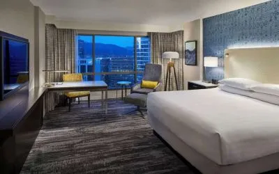Day use room with TV, work desk and sofa at Hyatt Regency Vancouver.