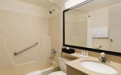 Guest bathroom with tub and free toiletries at Travelodge Edmonton South.