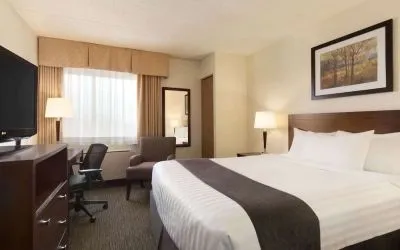 Standard day use room with TV, work desk, sofa and private bathroom at Travelodge Edmonton South.