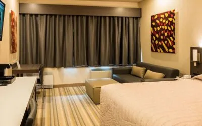 Day use room with living area and work desk at Le Chabrol Hotel Et Suites.