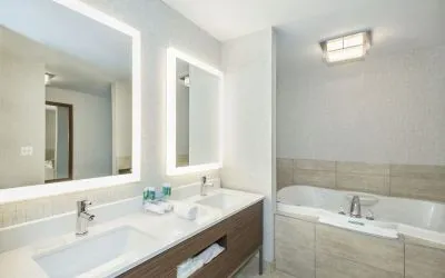 Guest bathroom with tub and free toiletries at Holiday Inn Express & Suites Medicine Hat.