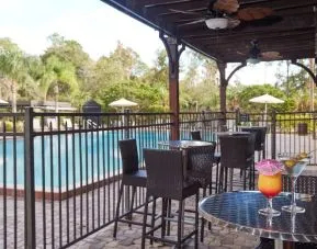 Outdoor seats beside the pool at Holiday Inn Orlando SW - Celebration Area.