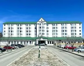 Hotel exterior and parking area at Divya Sutra Plaza & Conference Centre.