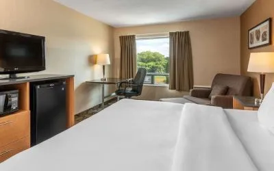 Standard day use room with TV, work desk and sofa at Comfort Inn Pembroke.
