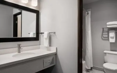 Guest bathroom with shower and tub at Garner By IHG.