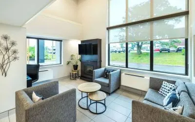 Stylish lobby lounge with TV screen, fireplace and comfortable seating at Comfort Inn Charlottetown.