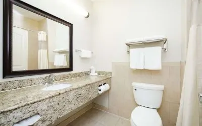 Guest bathroom with shower at Best Western Sugar Land Inn.