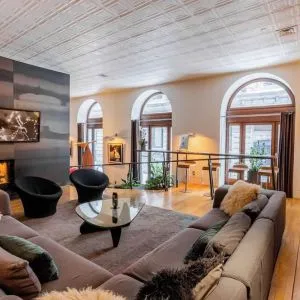 Lobby lounge with fireplace and workspace at Hotel Gault.
