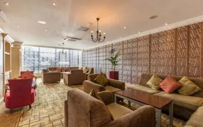 Bright and spacious lobby lounge with comfortable seating perfect for co-working at Thistle London Heathrow Terminal 5.