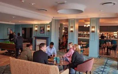 Dining area with comfortable seating and billiards at Thistle London Heathrow Terminal 5.