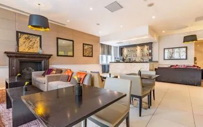 Hotel bar with comfortable seating and fireplace at Thistle Holborn, The Kingsley Hotel.