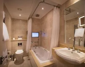 Guest bathroom with tub at The Royal Horseguards Hotel.