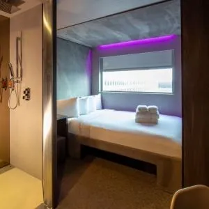 Day use room with work desk, private bathroom and window with view to the airport at Bloc Hotel.
