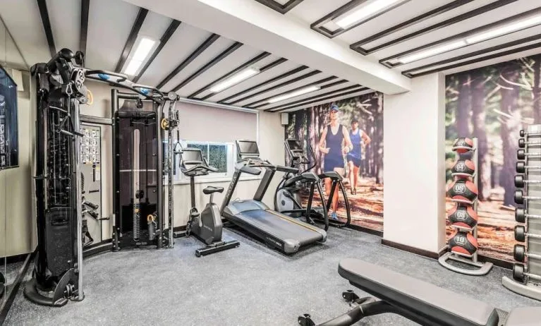 Fully equipped fitness center at Mercure Hotel London Hyde Park.