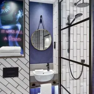 Guest bathroom with shower at NYX Hotel London Holborn By Leonardo.
