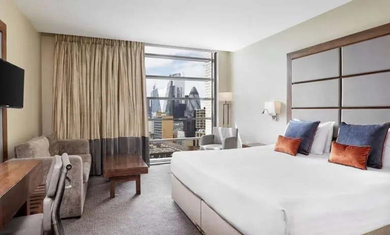 Day use room with TV, work desk and city view at Leonardo Royal Hotel London Tower Bridge.