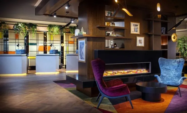 Lobby lounge with fireplace at Leonardo Royal Hotel London City.
