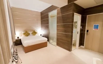 Bright and spacious day use room with private bathroom and workspace at The Wesley Euston Hotel.