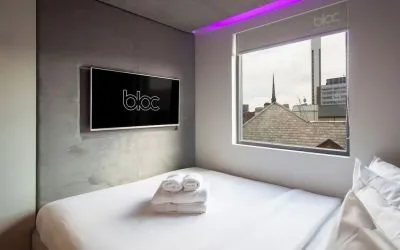 Day use room with TV screen and city view at Bloc Hotel Birmingham.