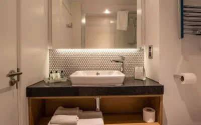 Guest bathroom with shower and free toiletries at Holiday Inn Leicester-Wigston.
