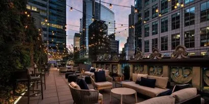 Rooftop terrace seating at The Knickerbocker Hotel.