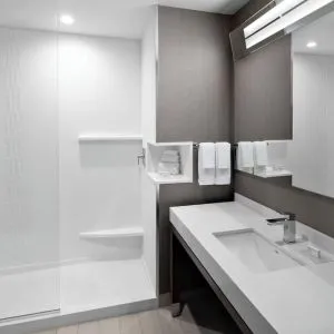 Guest bathroom with shower at Courtyard Delray Beach.
