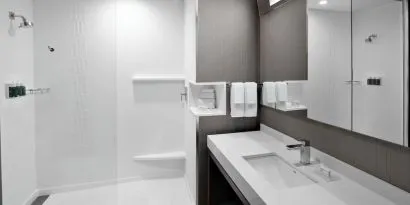 Guest bathroom with shower at Courtyard Delray Beach.
