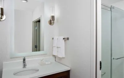 Guest bathroom with shower at Homewood Suites By Hilton Nashville.
