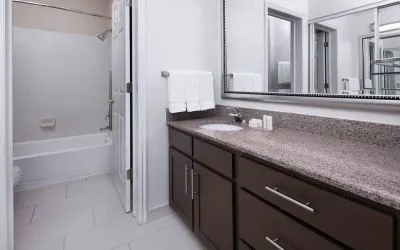 Guest bathroom with shower and tub at Residence Inn By Marriott Provo.