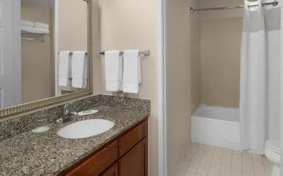 Guest bathroom with shower and tub at Residence Inn By Marriott San Diego Downtown.
