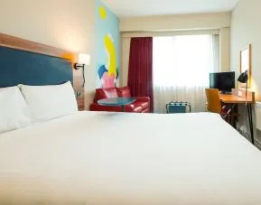 Day use room with work desk and sofa at ibis Styles Birmingham NEC.